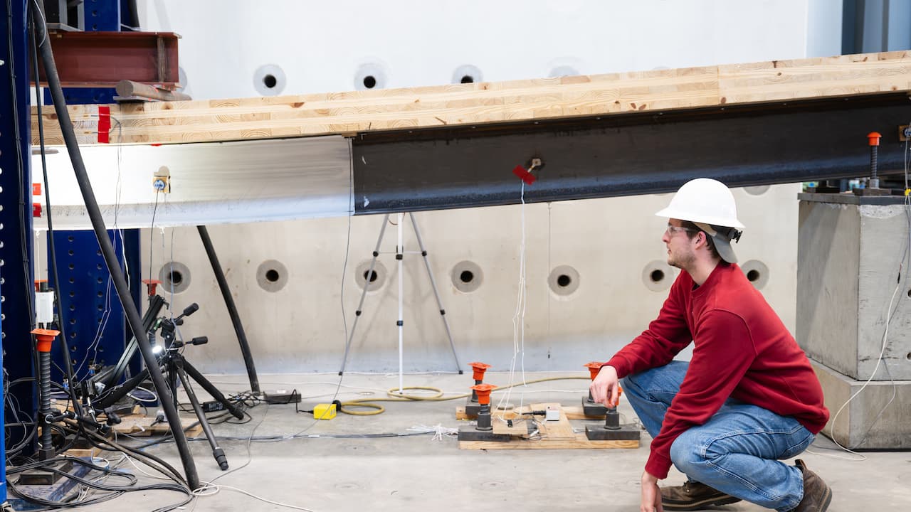 student testing large wood beam