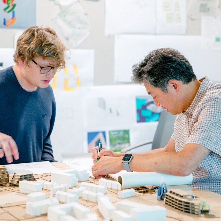 student and professor working together on a building model